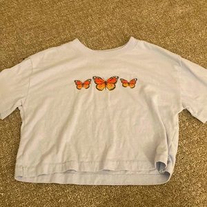 This is a butterfly shirt that is cropped and is great for anytime wear!!